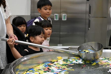 調理用柄杓で大鍋から水を汲む様子